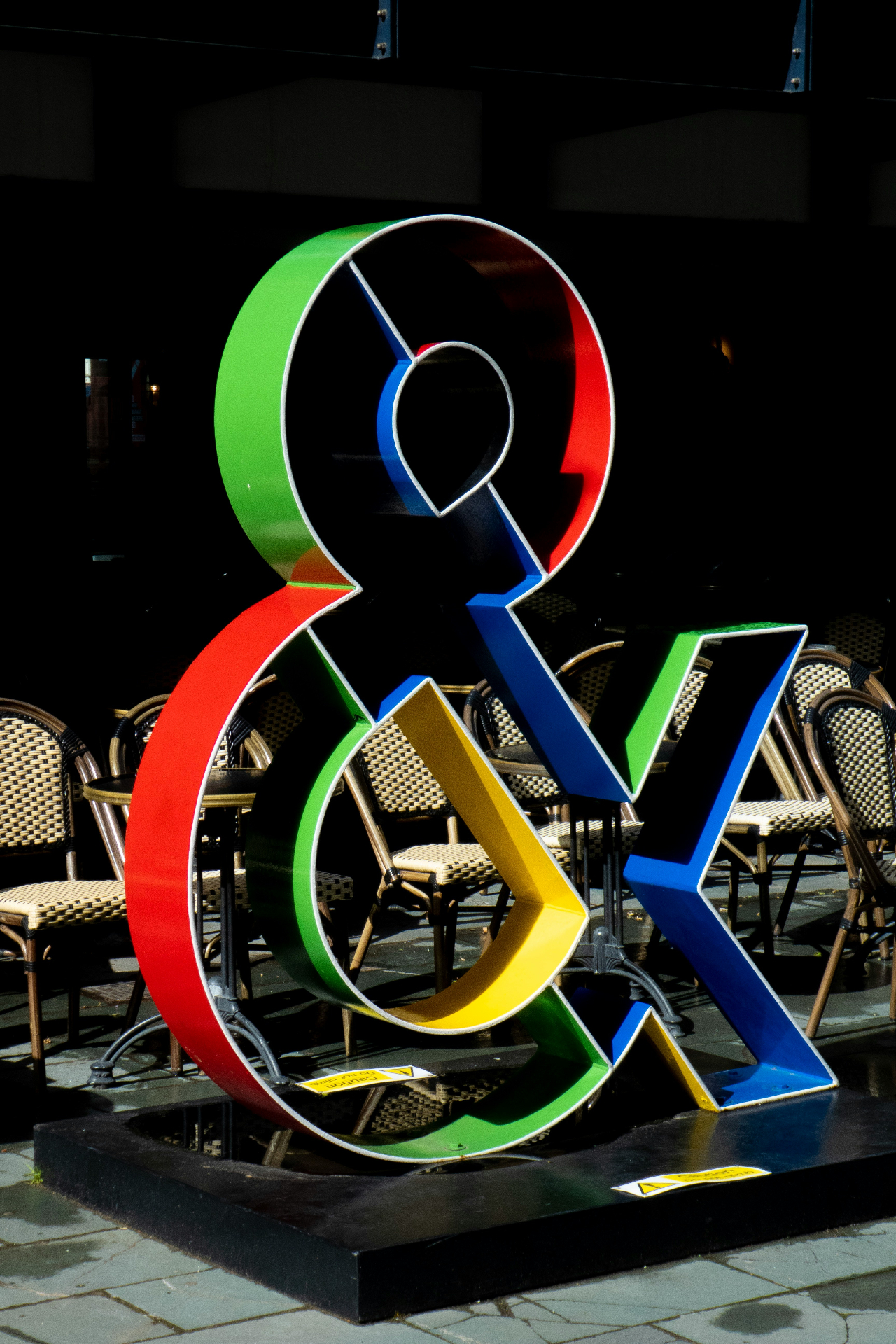 Colourful ampersand sculpture outside a café terrace